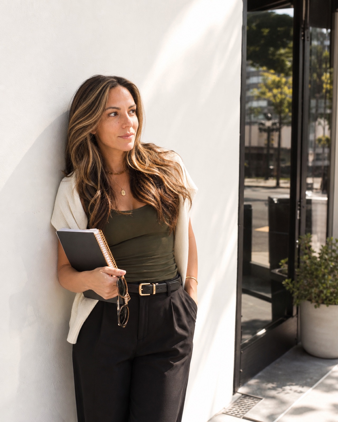 Liz holding a notebook outdoors